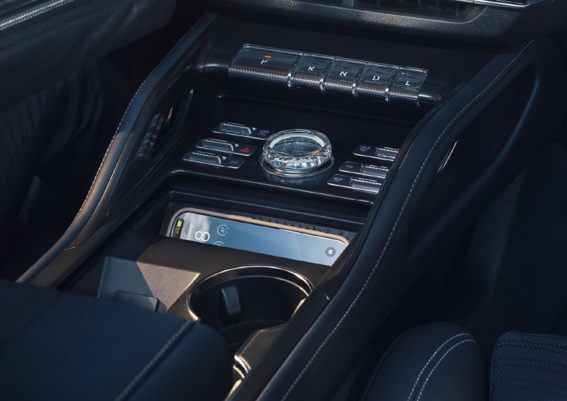 A smartphone is shown charging in the wireless charging pad. | Evergreen Lincoln in Issaquah WA