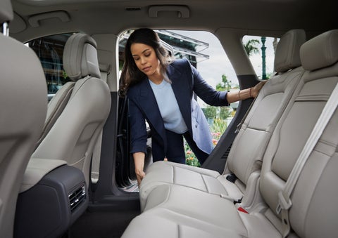 A woman slides the second-row seat forward to create more cargo space | Evergreen Lincoln in Issaquah WA