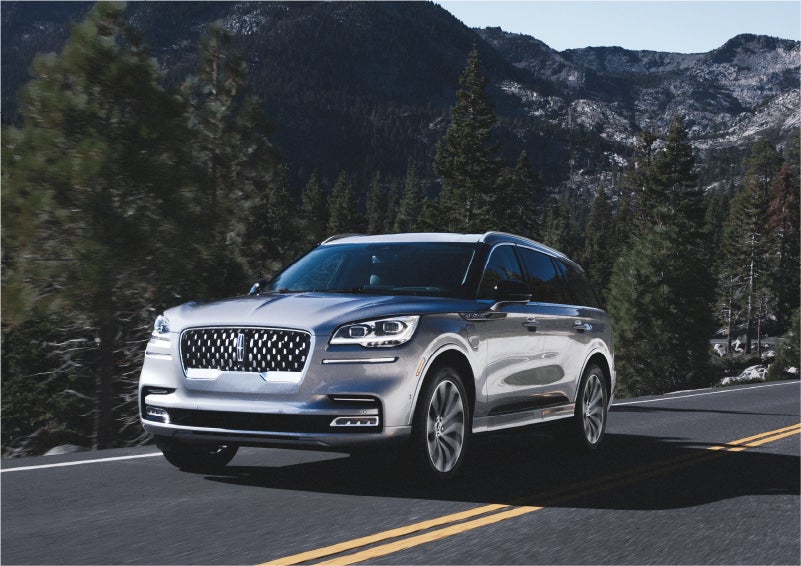 A 2023 Lincoln Aviator® Grand Touring SUV being driven on a winding road to demonstrate the capabilities of all-wheel drive | Evergreen Lincoln in Issaquah WA