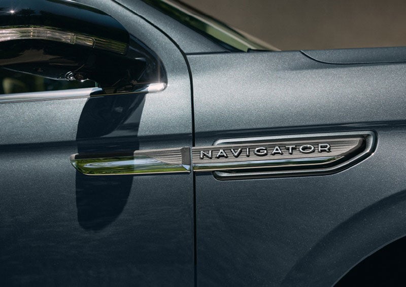 The nameplate badge near the passenger sideview mirror on 2023 Lincoln Navigator SUV shows off geometric design. | Evergreen Lincoln in Issaquah WA